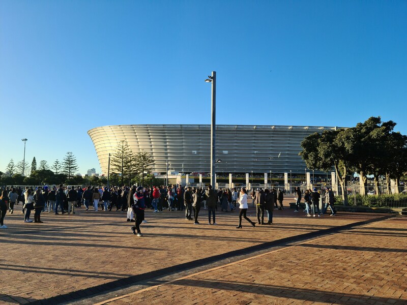 A crowd of people walking around Cape Town Stadium in Green Point